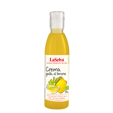 Auf dem Bild ist eine Flasche mit gelber Zitronencreme der Marke LaSelva zu sehen, die als ideal für Fisch- und Dessertgerichte beworben wird.